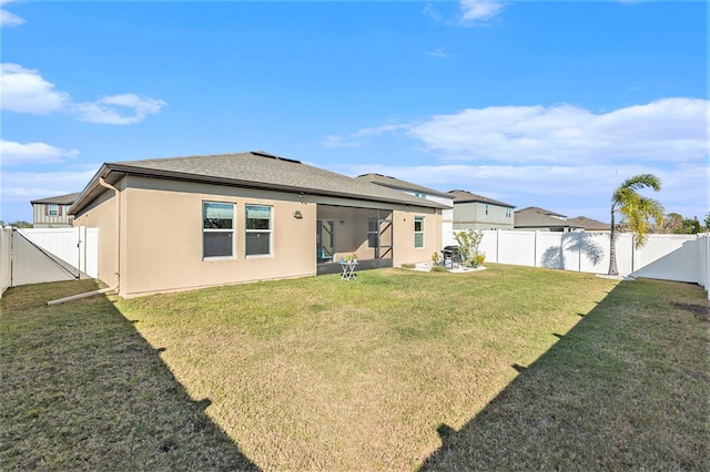 back of house featuring a yard