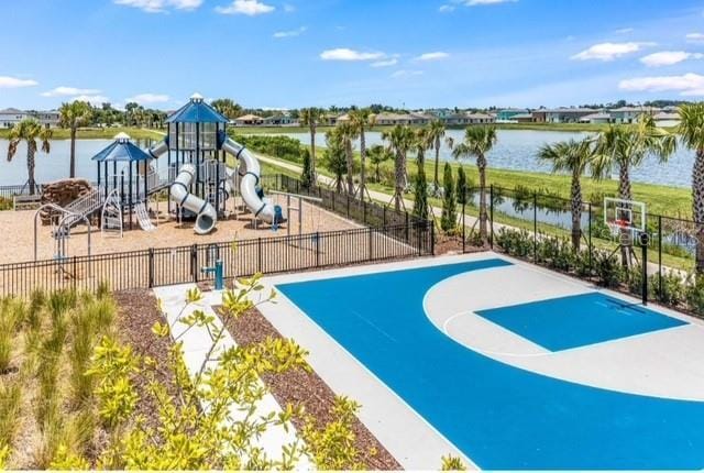 exterior space featuring a water view and basketball hoop