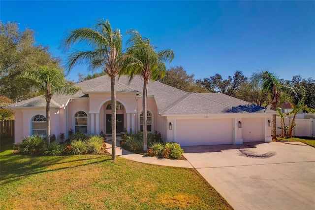 view of front facade featuring a garage and a front yard