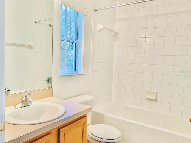 full bathroom with tiled shower / bath, vanity, and toilet