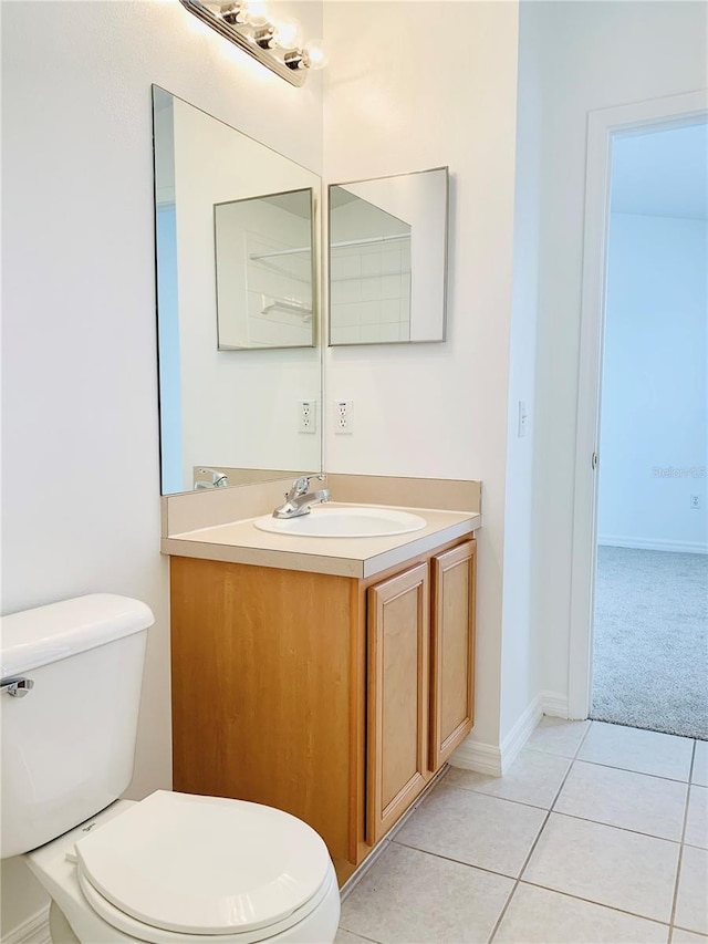 bathroom with vanity, tile patterned floors, and toilet