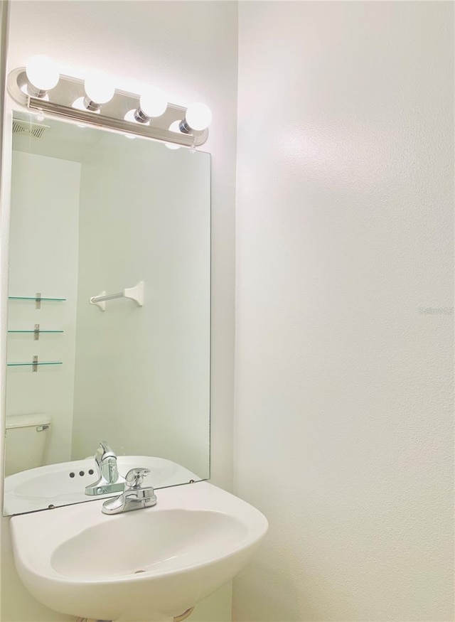 bathroom featuring sink and toilet