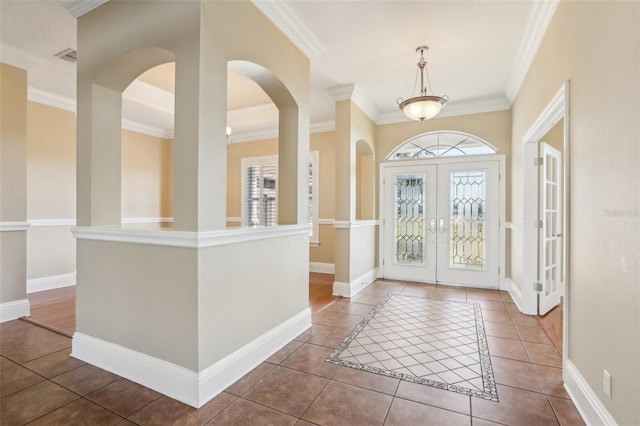 entrance foyer featuring tile patterned flooring, ornamental molding, and french doors