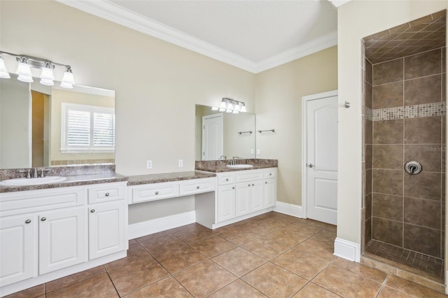 bathroom with crown molding, tiled shower, vanity, and tile patterned floors