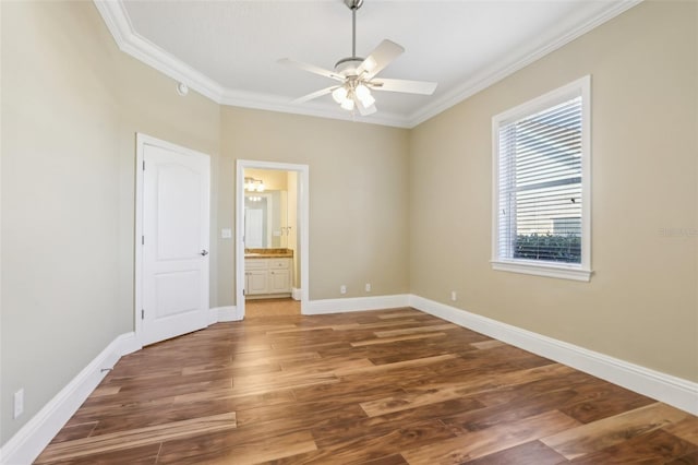 unfurnished bedroom with ornamental molding, dark hardwood / wood-style floors, connected bathroom, and ceiling fan