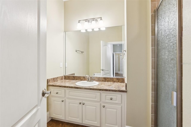 bathroom with vanity and a shower with door