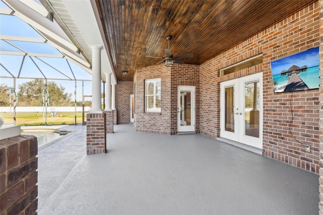 view of patio / terrace featuring french doors, ceiling fan, and glass enclosure