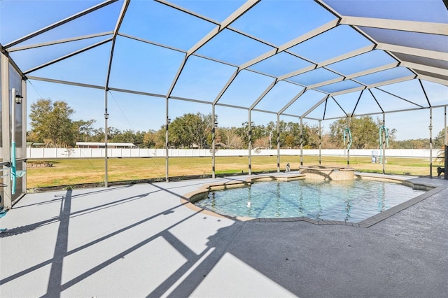 view of swimming pool featuring a yard, a lanai, and a patio area