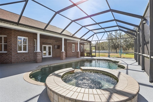 view of pool with french doors, an in ground hot tub, a patio area, and a lanai