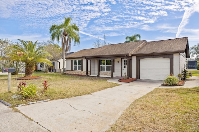 single story home featuring a garage and a front yard