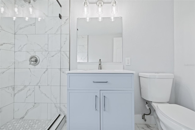 bathroom featuring vanity, tiled shower, and toilet