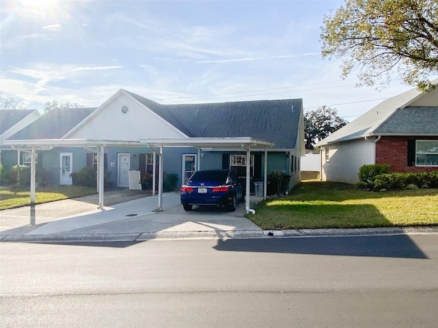 view of front of house with a carport and a front lawn