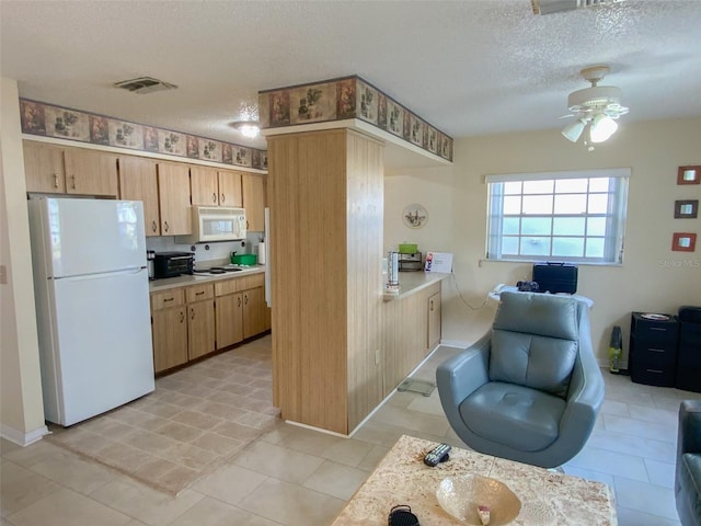 kitchen with ceiling fan, white appliances, and a textured ceiling