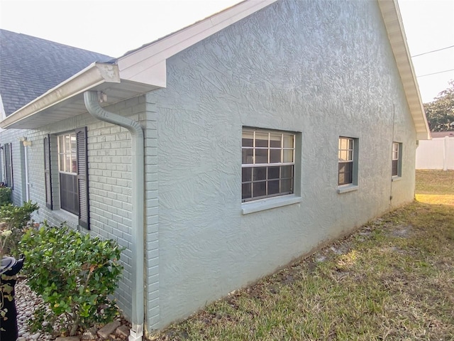 view of side of home featuring a lawn