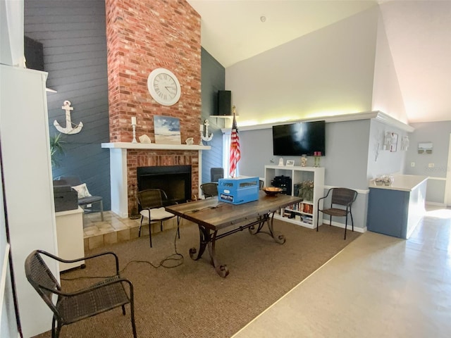 living room featuring a brick fireplace and high vaulted ceiling