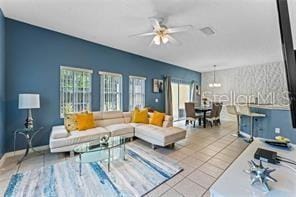 living room with ceiling fan and tile patterned flooring