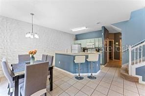 dining room with an inviting chandelier and light tile patterned floors