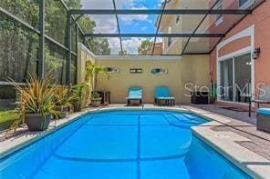 view of pool with a lanai and a patio area