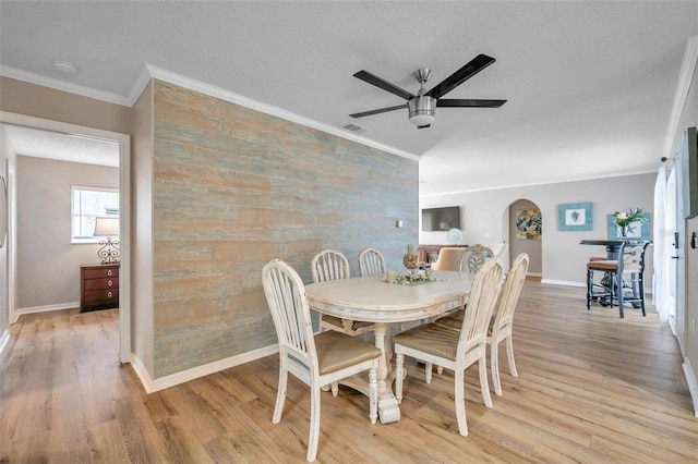 dining area featuring crown molding and light hardwood / wood-style floors