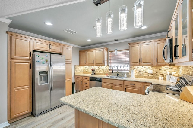 kitchen with decorative light fixtures, kitchen peninsula, stainless steel appliances, and sink