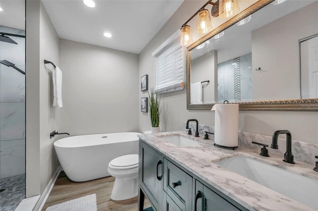 full bathroom with toilet, plus walk in shower, vanity, and wood-type flooring