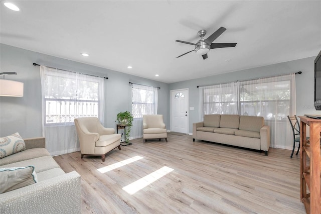 living room with ceiling fan and light hardwood / wood-style floors