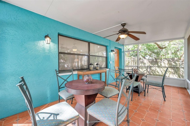 sunroom / solarium featuring ceiling fan