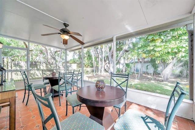 sunroom / solarium featuring ceiling fan