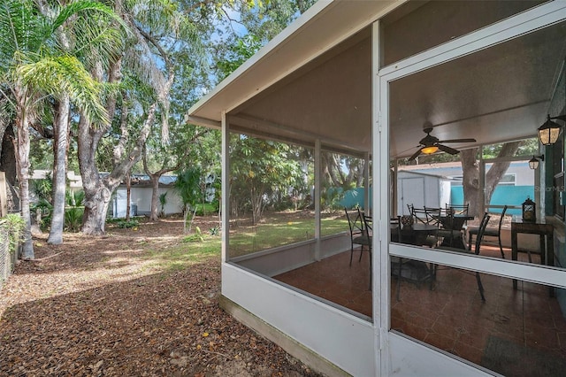 exterior space featuring ceiling fan and a sunroom