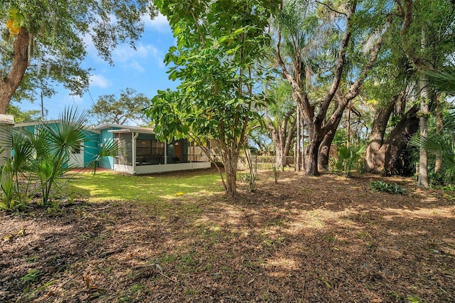 view of yard featuring a sunroom