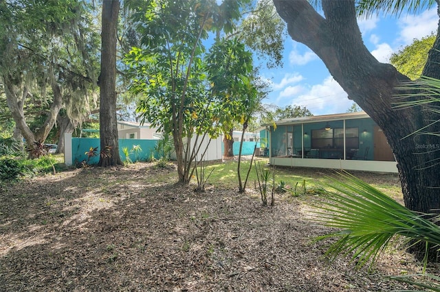 view of yard featuring a sunroom