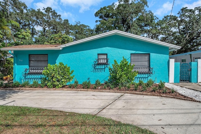 717 Carolina Ave, Tarpon Springs, FL 34689 - view of front of property with stucco siding and a gate