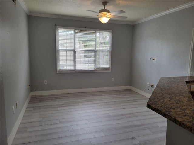 unfurnished dining area featuring a textured ceiling, light hardwood / wood-style flooring, ornamental molding, and ceiling fan