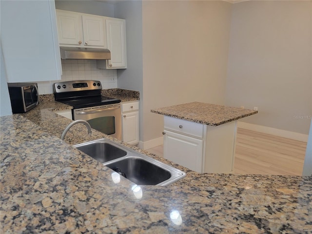 kitchen with electric stove, sink, white cabinetry, and backsplash