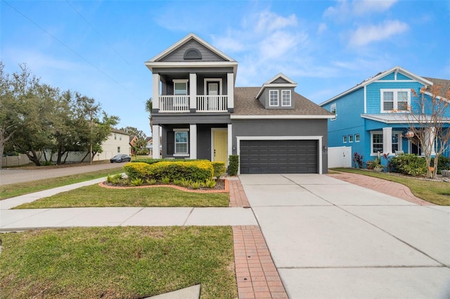 view of front of house with a garage, a front lawn, and a balcony