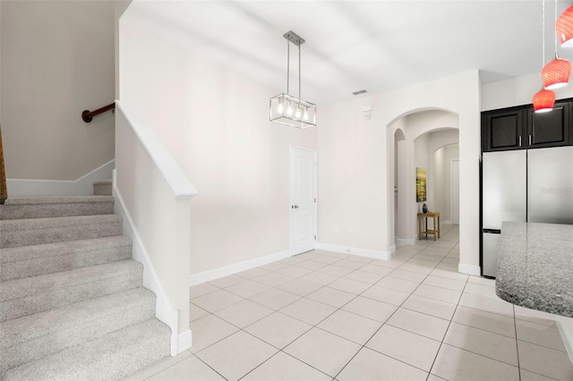 staircase featuring tile patterned floors