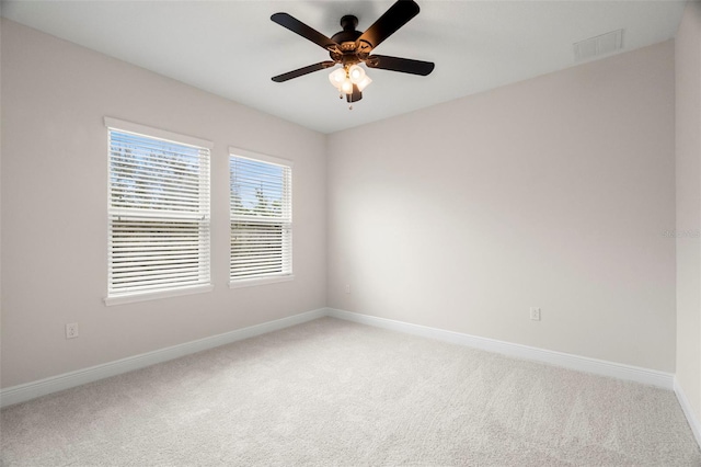 spare room featuring carpet and ceiling fan