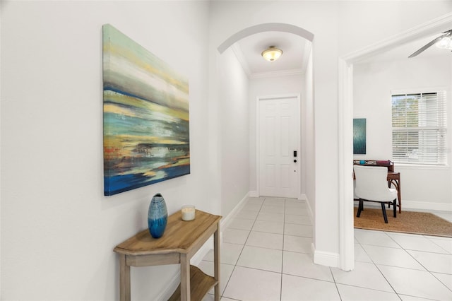 entryway featuring crown molding, light tile patterned floors, and ceiling fan