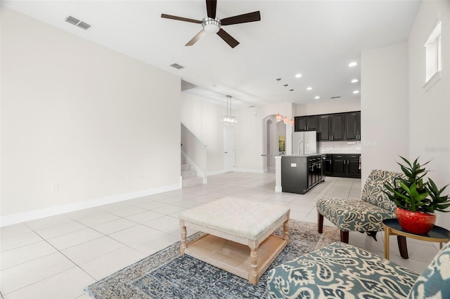 tiled living room with sink and ceiling fan