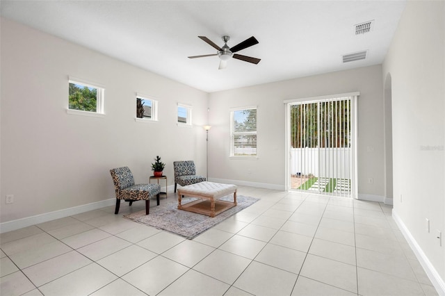 sitting room featuring light tile patterned flooring and ceiling fan