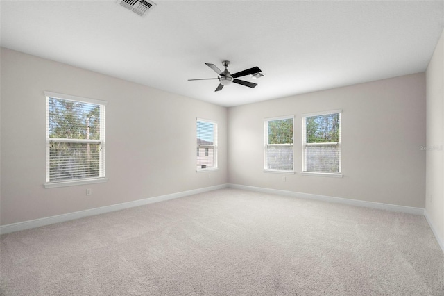 unfurnished room with ceiling fan and light carpet