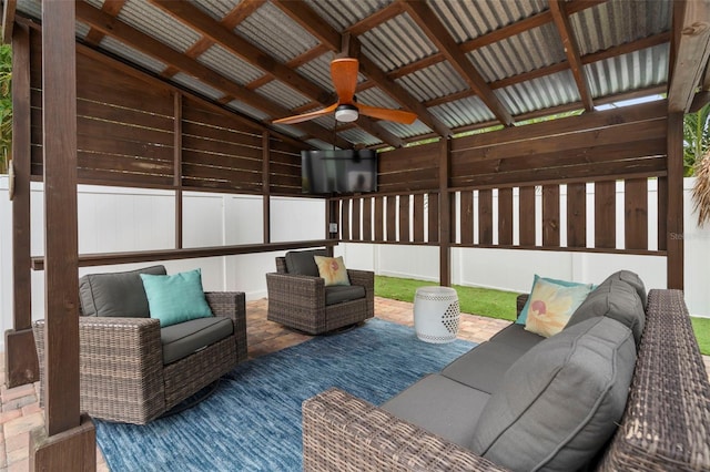 interior space with outdoor lounge area and ceiling fan