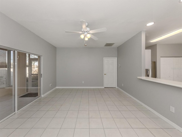 empty room featuring light tile patterned floors and ceiling fan