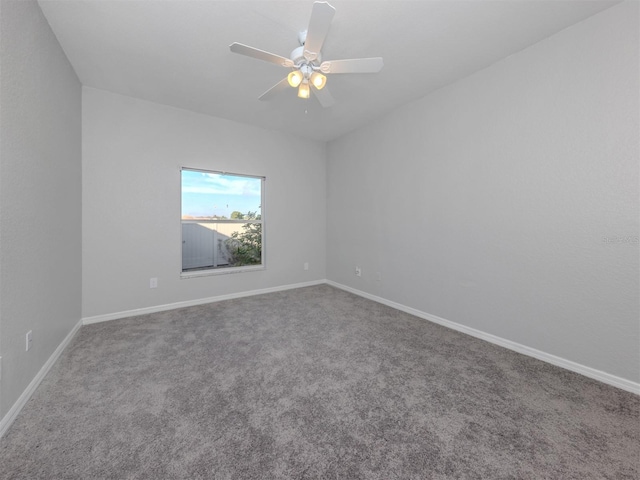 carpeted spare room featuring ceiling fan