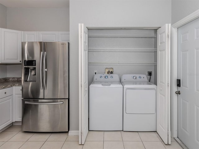 laundry room with light tile patterned floors and independent washer and dryer