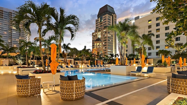 pool at dusk with a patio