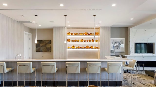 kitchen featuring hanging light fixtures and a kitchen breakfast bar