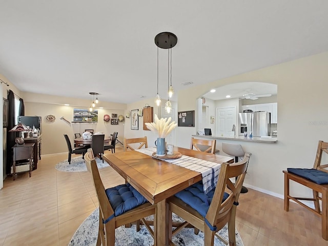 dining area featuring light tile patterned flooring and sink