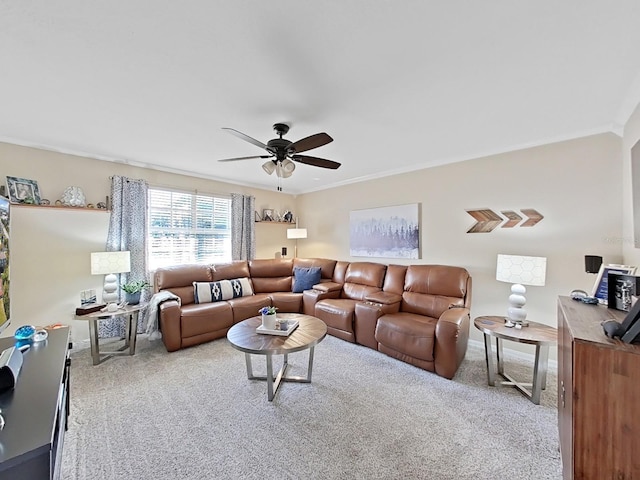 living room featuring crown molding, light colored carpet, and ceiling fan