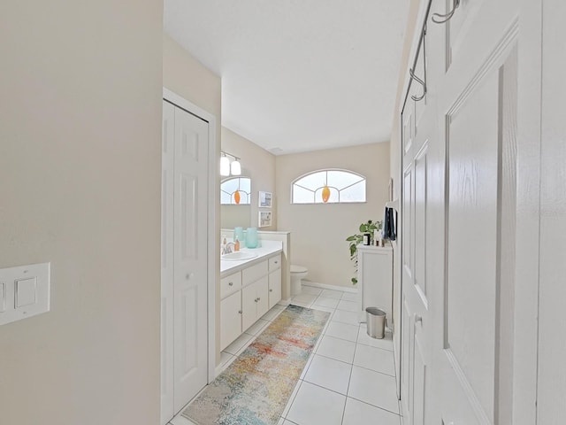 bathroom with vanity, toilet, and tile patterned flooring